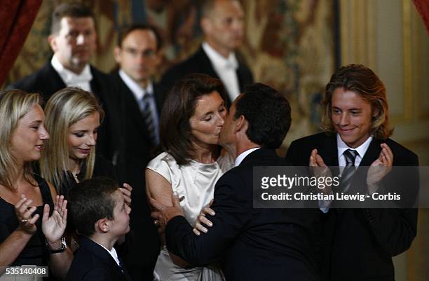 Newly-inaugurated French President Nicolas Sarkozy kisses his wife Cecilia Sarkozy in the company of their children at the handover ceremony at the...