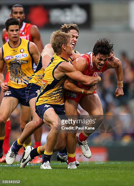 Mark LeCras and Mark Hutchings of the Eagles tackle Jesse Lonergan of the Suns during the round 10 AFL match between the West Coast Eagles and the...