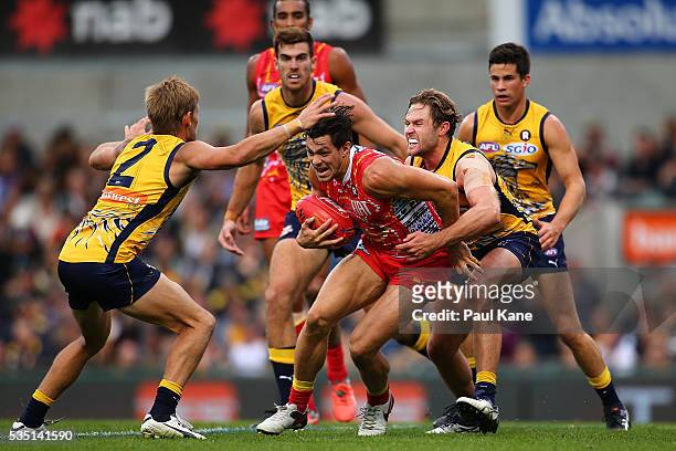Mark LeCras and Mark Hutchings of the Eagles tackle Jesse Lonergan of the Suns during the round 10 AFL match between the West Coast Eagles and the...