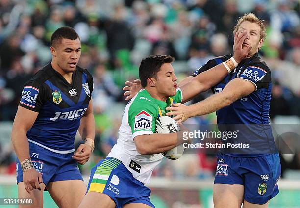 Joseph Tapine of the Raiders is tackled during the round 12 NRL match between the Canberra Raiders and the Canterbury Bulldogs at GIO Stadium on May...
