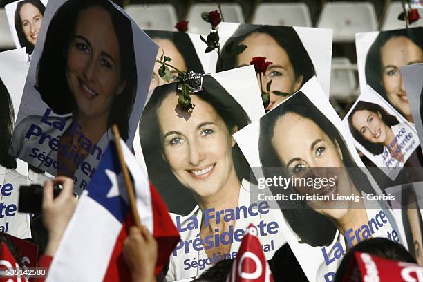 Supporters hold signs of Socialist presidential candidate Segolene Royal and roses, symbol of the French Socialist party, at a campaign rally for...