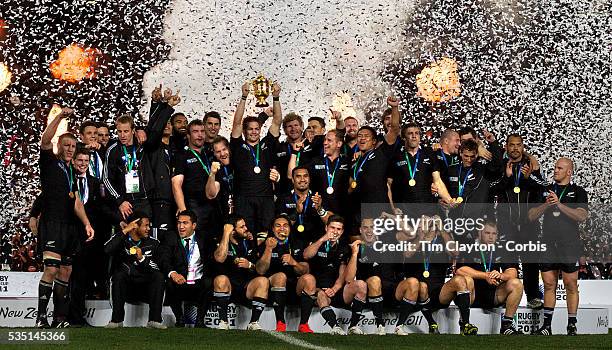 New Zealand Captain Richie McCaw lifts the trophy as his team mates celebrate after New Zealand's 8-7 victory over France in the Final of the IRB...