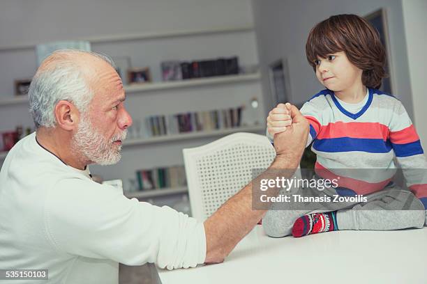 small boy with his grandfather - arm wrestle stock pictures, royalty-free photos & images