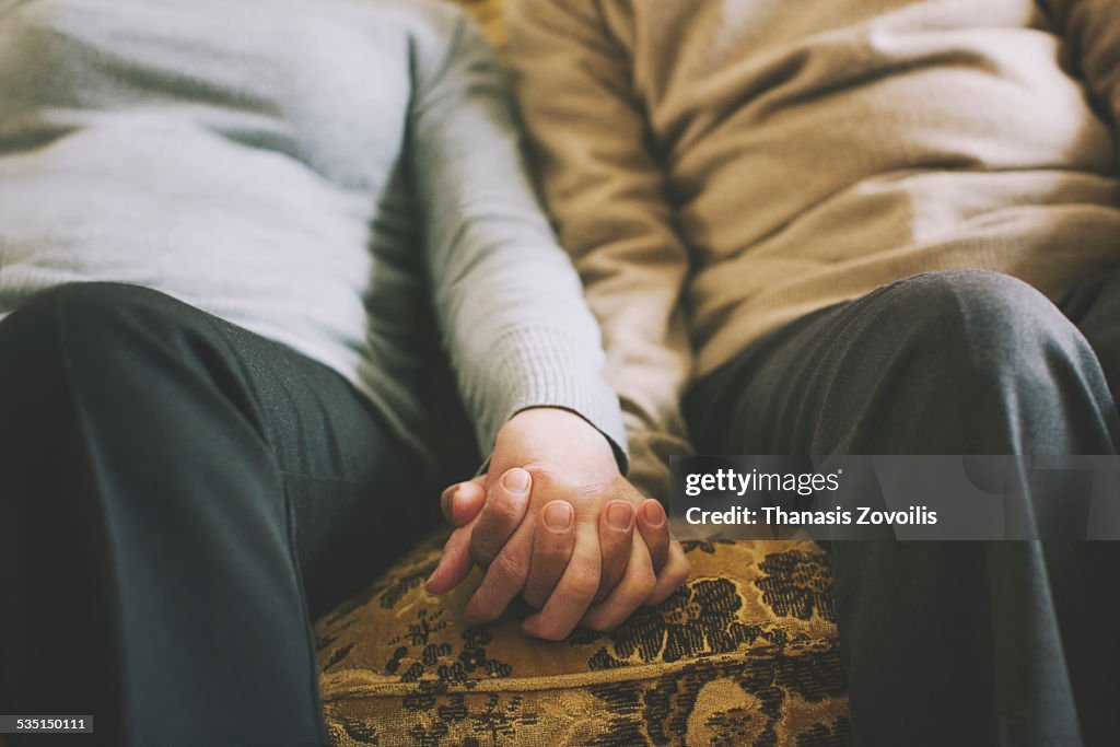 Senior couple holding hands