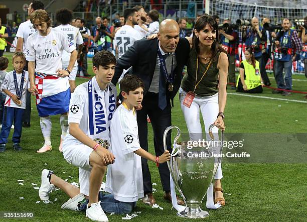 Coach of Real Madrid Zinedine Zidane, his wife Veronique Zidane and two of their sons Theo Zidane and Elyaz Zidane pose with the trophy following the...
