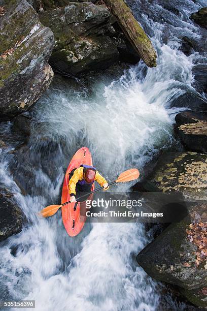 kayaker kayaking in fast rapids - kayaking rapids stock pictures, royalty-free photos & images