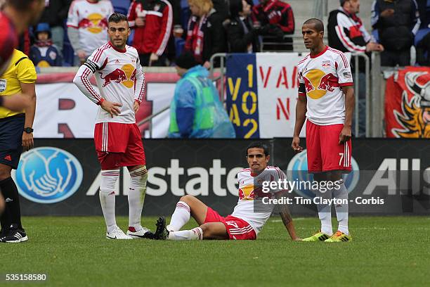 Tim Cahill, , New York Red Bulls, injured as team mates Armando, , and Roy Miller, summon the trainer. Cahill left the match in the 27th minute...