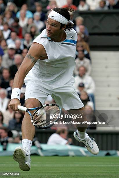 Spanish professional tennis player Carlos Moya pictured in action against Tim Henman of Great Britain in the first round of the Men's Singles...