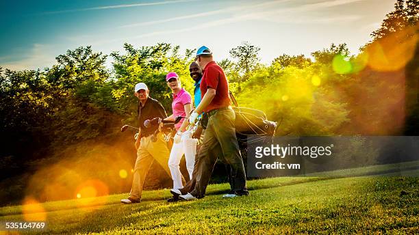 friends playing golf on a beautiful sunny day - golf stock pictures, royalty-free photos & images