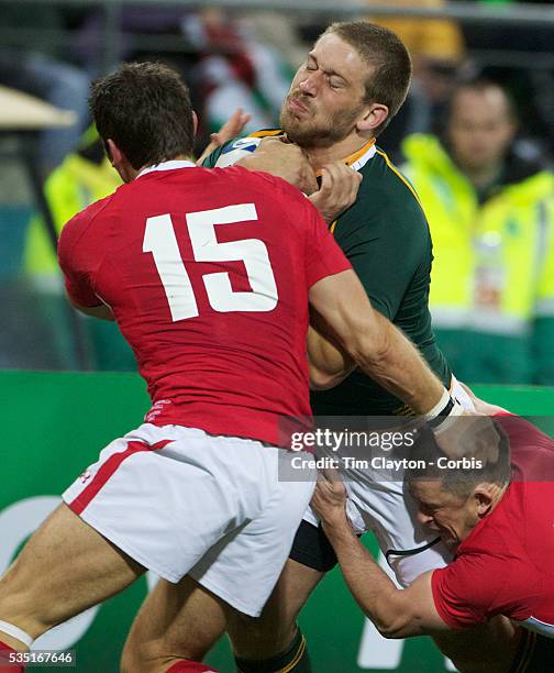 Frans Steyn, South Africa, holds off the challenge of Shane Williams and James Hook , to score a try during the Wales V South Africa, Pool D match...