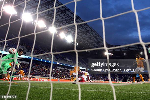 Bradley Wright-Phillips, New York Red Bulls, scores the first of his hat-trick of goals as he beats Houston Dynamo goalkeeper Tally Hall during the...