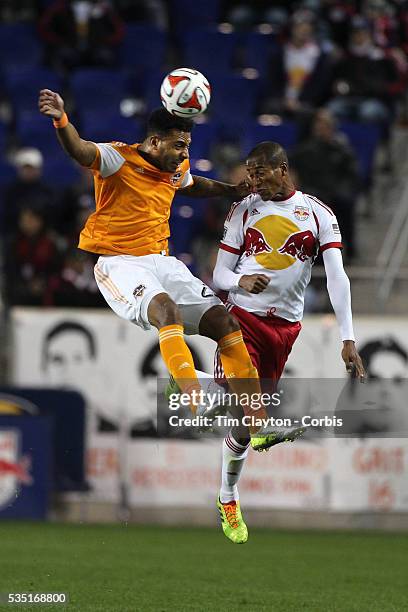 Giles Barnes, , Houston Dynamo, wins a header while challenged by Roy Miller, New York Red Bulls during the New York Red Bulls V Houston Dynamo,...