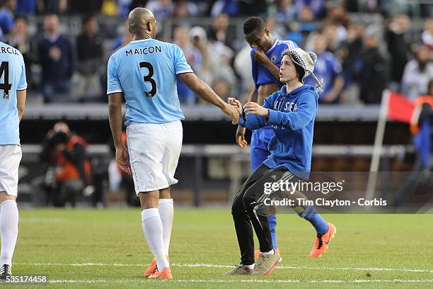Fan runs onto the field at the end of the game and confronts Maicon Sisenando, Manchester City, during the Manchester City V Chelsea friendly...