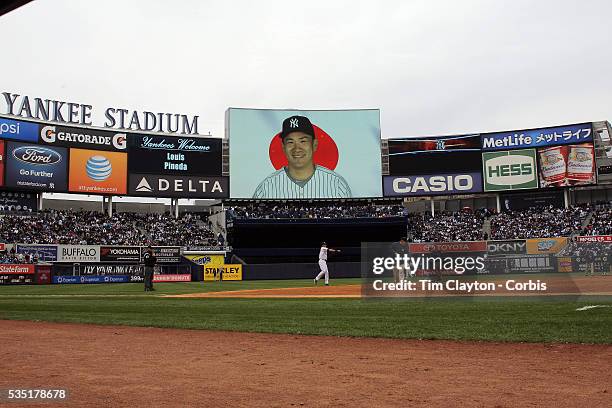 Masahiro Tanaka, New York Yankees, on the stadium screen helping fans with Japanese language lessons as Derek Jeter warms up before the New York...