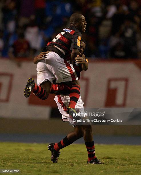 Renato of Flamengo is congratulated by team mate Toro after scoring his sides third goal from a blistering free kick during the Flamengo V...