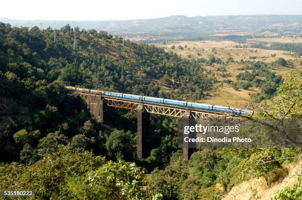 a indian railways train passes through the kasara ghat in maharashtra, india. - india train stock pictures, royalty-free photos & images