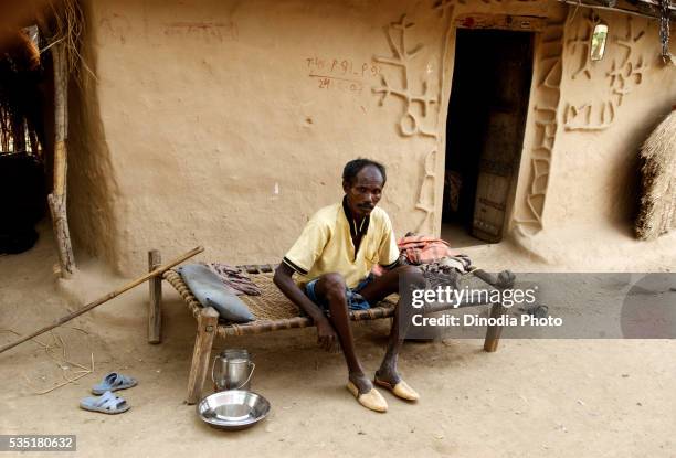 rural man sitting on a charpoy in rajouli, nawada, bihar, india. - charpoy stock pictures, royalty-free photos & images