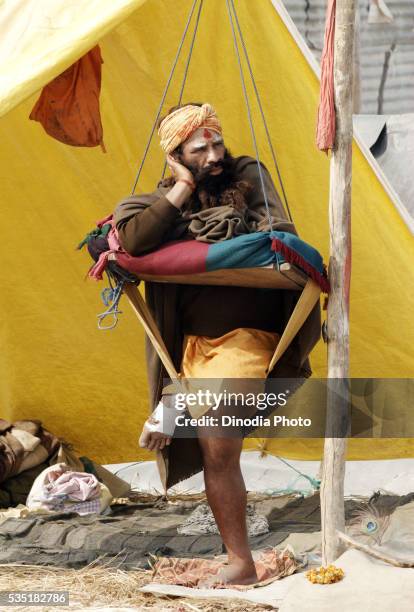 a naga sadhu from the juna akadha during the ardh kumbh mela in allahabad, uttar pradesh, india. - allahabad ストックフォトと画像