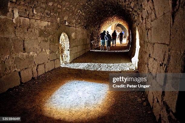 tourists in tunnel in karak castle in jordan - jordanian stock pictures, royalty-free photos & images