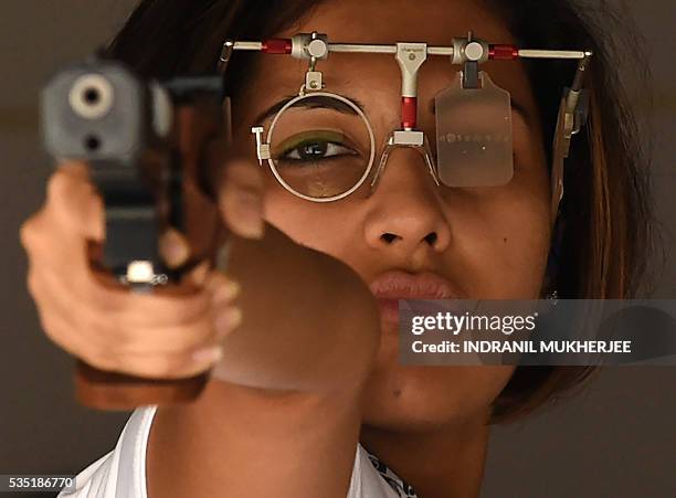 Indian shooter Heena Sidhu concentrates before taking a shot during a training session at the Maharshtra Rifle Association firing range in Mumbai on...