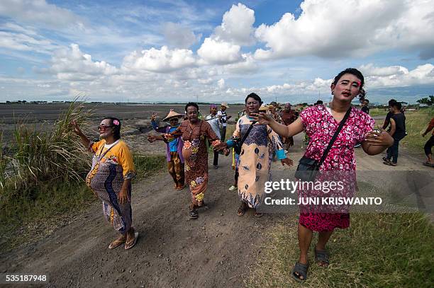 Survivors dressed as women, to show their support for the women who lost their livelihoods, take part in a parade to mark the 10th anniversary of the...