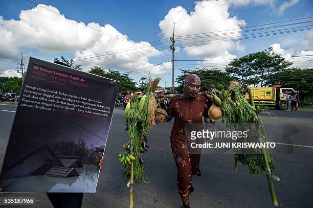 Survivor dressed as a woman, to show his support for the women who lost their livelihoods, takes part in a parade to mark the 10th anniversary of the...
