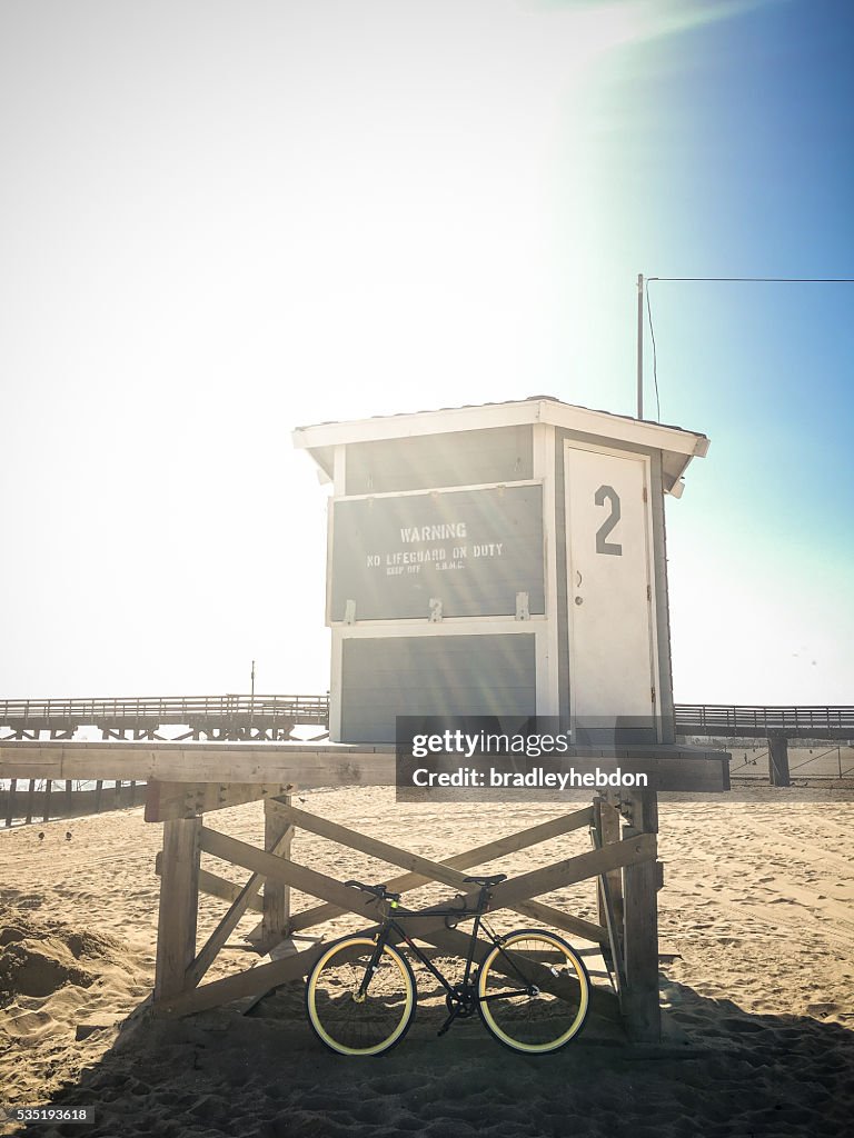 Bike leaning against lifeguard hut on beach