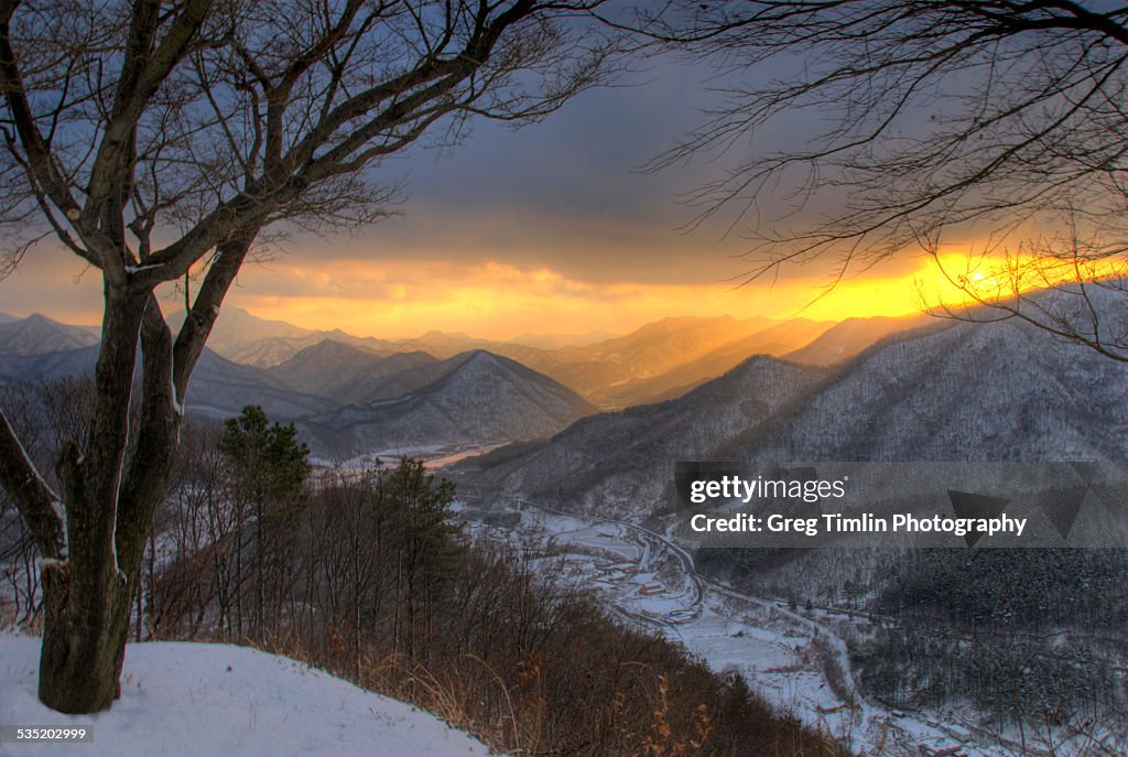 Winter valley under golden sunset