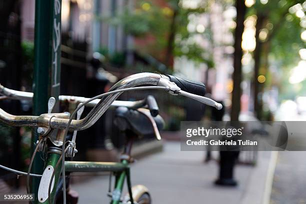 bicycle parked on the sidewalk - east village stock-fotos und bilder
