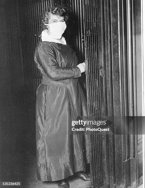 Female Elevator operator in New York City, NY, wearing a mask to protect against Spanish flu, New York, October 16, 1918.