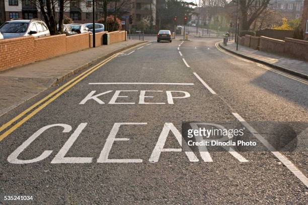 keep clear painted on the road in harrow, london, united kingdom. - harrow london stock pictures, royalty-free photos & images