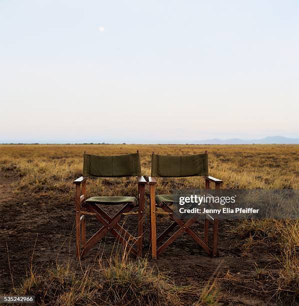 two folding chairs side by side - director's chair stock-fotos und bilder