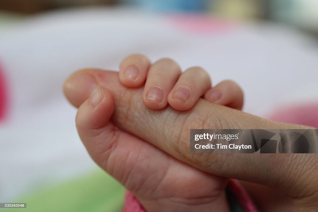 A two month old baby girl and mother.