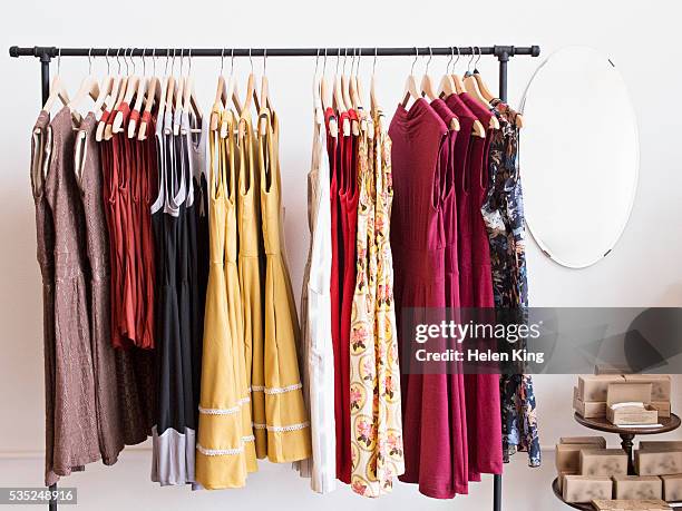 rack of dresses in boutique - fashion archive stockfoto's en -beelden