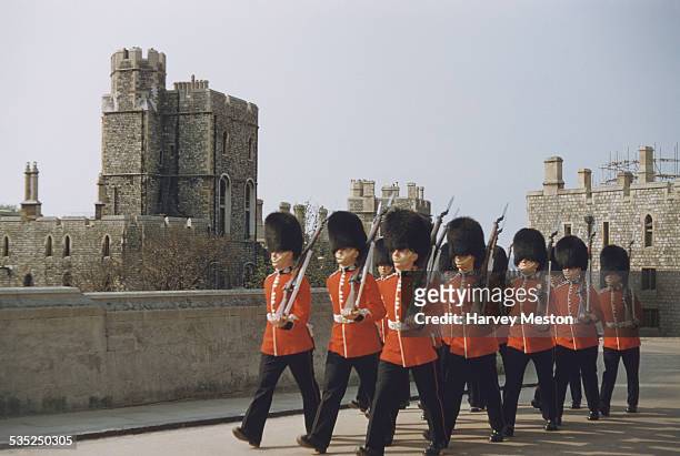 The Queen's Guards marching at Windsor Castle, Berkshire, England, circa 1960.