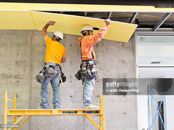 construction workers applying insulation - laborer ストックフォトと画像