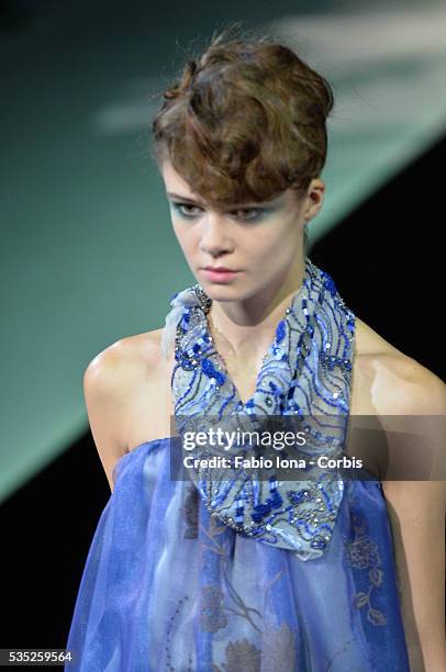 Model walks the runway at the Giorgio Armani Spring Summer 2014 fashion show during Milan Fashion Week on September 23, 2013 in Milan, Italy