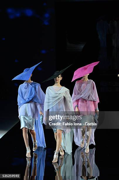 Model walks the runway at the Giorgio Armani Spring Summer 2014 fashion show during Milan Fashion Week on September 23, 2013 in Milan, Italy