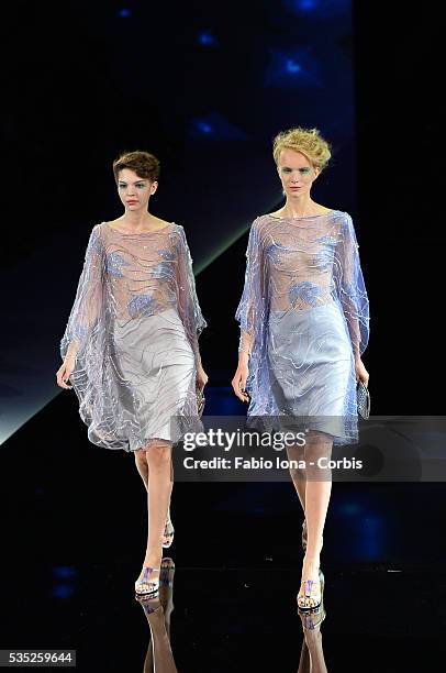 Model walks the runway at the Giorgio Armani Spring Summer 2014 fashion show during Milan Fashion Week on September 23, 2013 in Milan, Italy