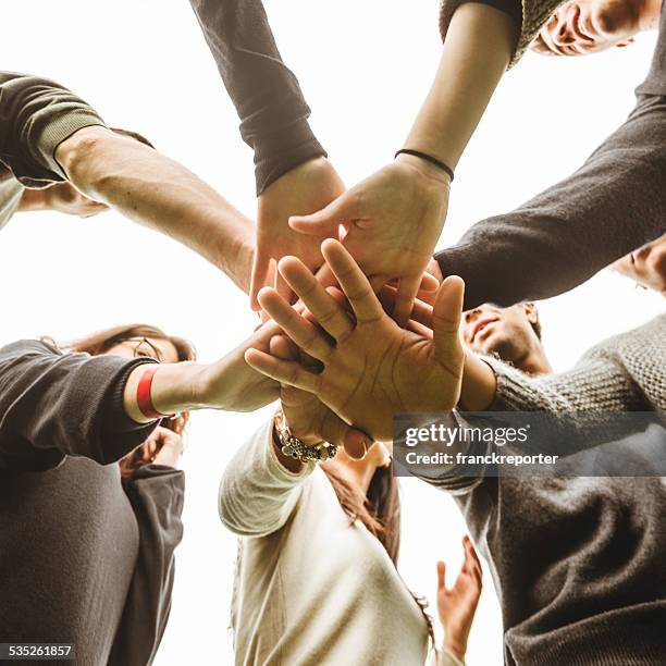 human fraternity - team hands in huddle stock pictures, royalty-free photos & images