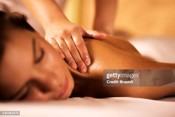 woman receiving back massage. - massage bildbanksfoton och bilder