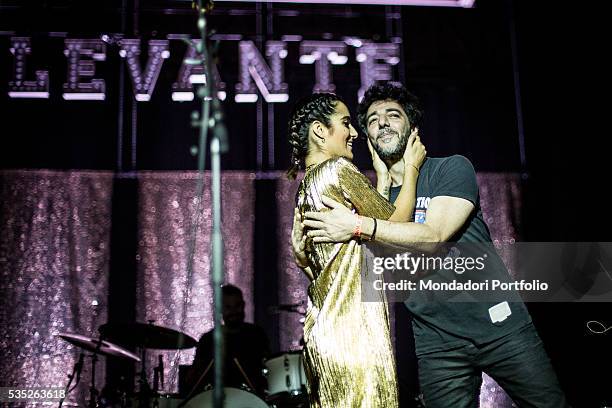 Italian singer-songwriter Levante hugging her partner Max Gazzé during her concert at the Alcatraz. In the back of the stage the sign saying Levante...