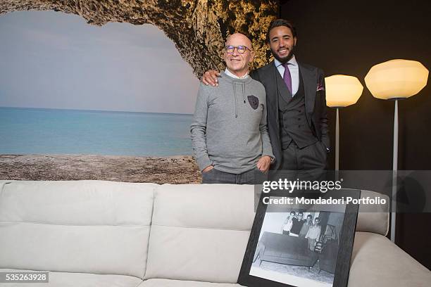 The entrepreneur Pasquale Natuzzi smiling with his son Pasquale Junior. On the sofa, one picture from 1959 with Pasquale Natuzzi and the entire staff...