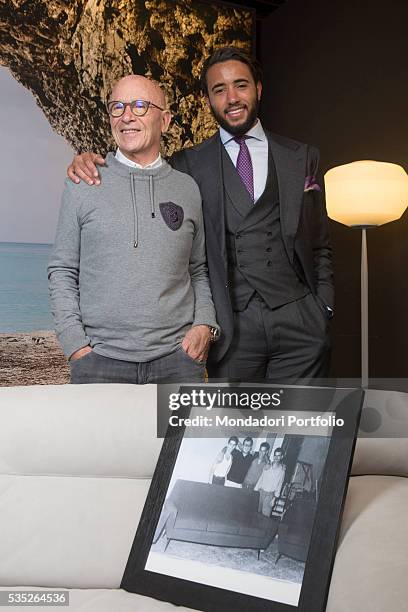 The entrepreneur Pasquale Natuzzi smiling with his son Pasquale Junior. On the sofa, one picture from 1959 with Pasquale Natuzzi and the entire staff...