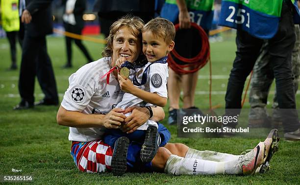 Luka Modric of Real Madrid celebrates victory with his son Ivano after winning the Champions League final match between Real Madrid and Club Atletico...