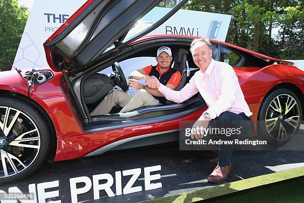 James Morrison of England poses with Dr Ian Robertson, Member of the Board BMW AG Sales and his new BMW i8 car after his hole-in-one on the 14th...