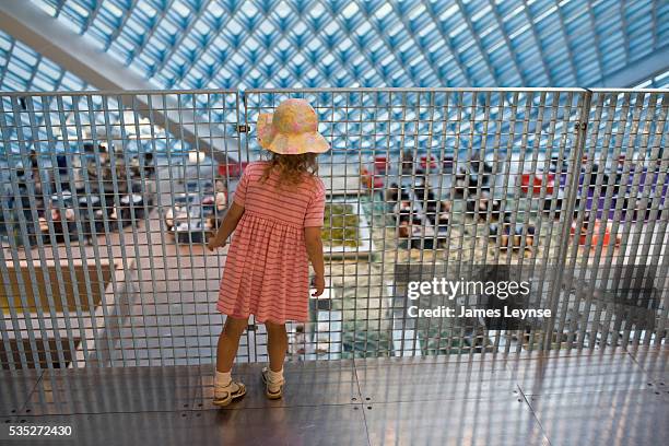 Young girl looks down to a lower level in The Seattle Central Library, which designed by the Dutch Architect Rem Koolhaas. It is the flagship library...