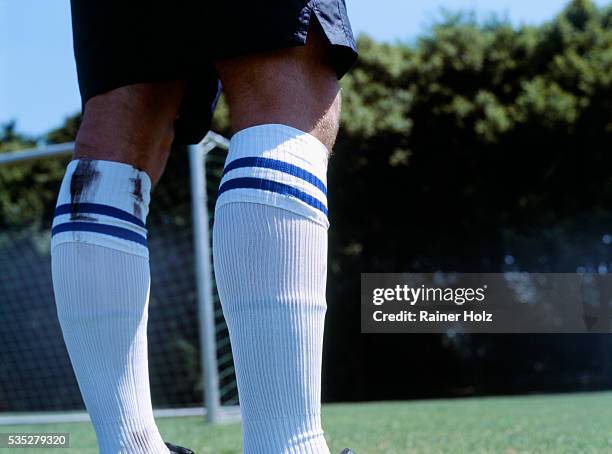 legs of a soccer player - dirty sock stock pictures, royalty-free photos & images