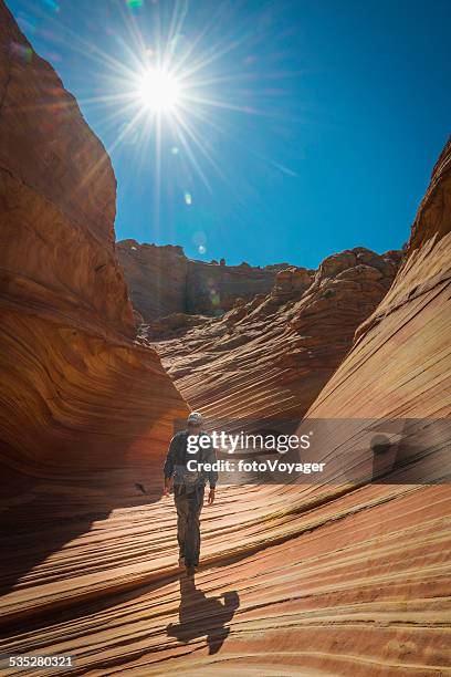 hiker walking through the wave iconic desert formation arizona usa - the swirl stock pictures, royalty-free photos & images