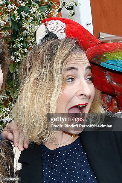 Actress Marilou Berry poses with parrot Arthur during Day Height of the 2016 French Tennis Open at Roland Garros on May 29, 2016 in Paris, France.